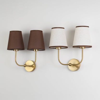 Double wall sconce with gold frame and brown fabric shades shown on a white background with lights off.
