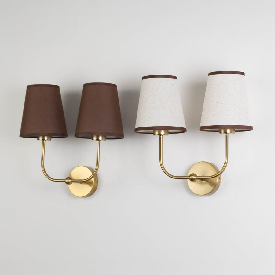 Double wall sconce with gold frame and brown fabric shades shown on a white background with lights off.