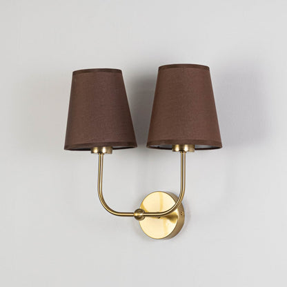 Gold metal double wall sconce with brown fabric shades shown on a plain white background for product clarity.