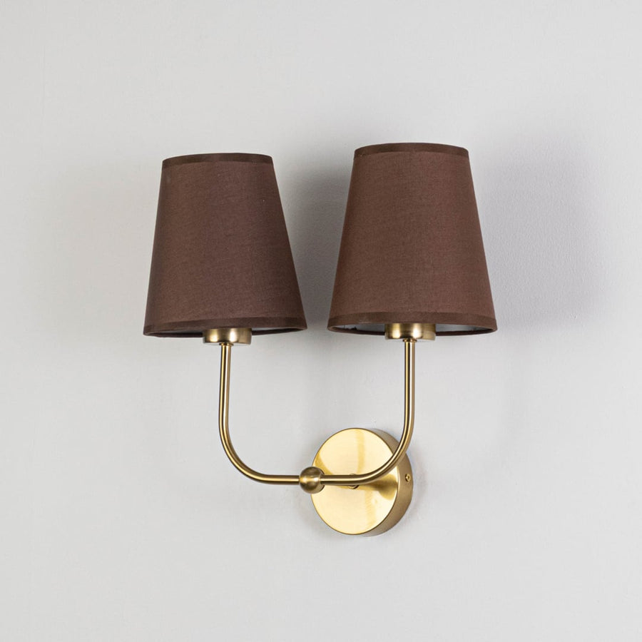 Gold metal double wall sconce with brown fabric shades shown on a plain white background for product clarity.