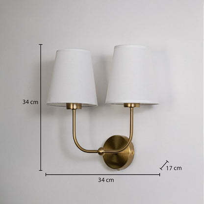 Gold metal double wall sconce with white shades shown with 34 cm height and 34 cm width for accurate size detail.