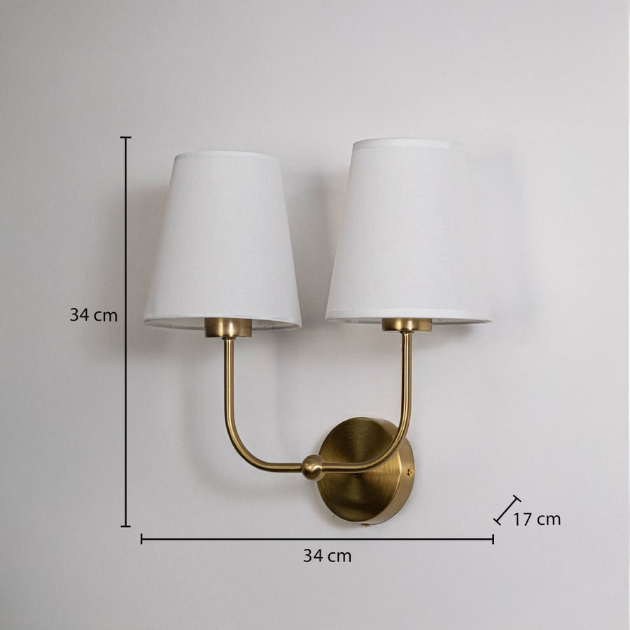 Gold metal double wall sconce with white shades shown with 34 cm height and 34 cm width for accurate size detail.