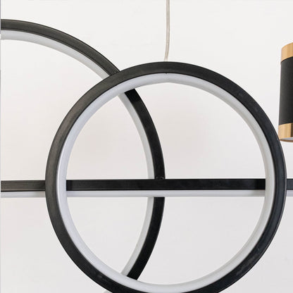 Closeup of pendant light featuring golden ring frame and dual cylindrical spotlights for modern home ceiling lighting decor.