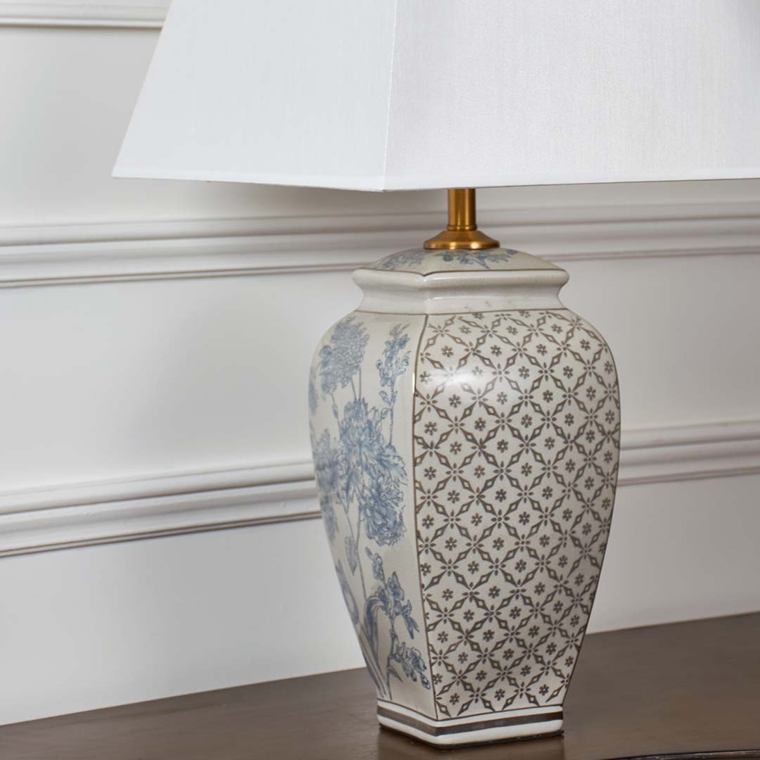 Detailed closeup of the ceramic lamp base showcasing blue floral motifs and precise geometric patterns.