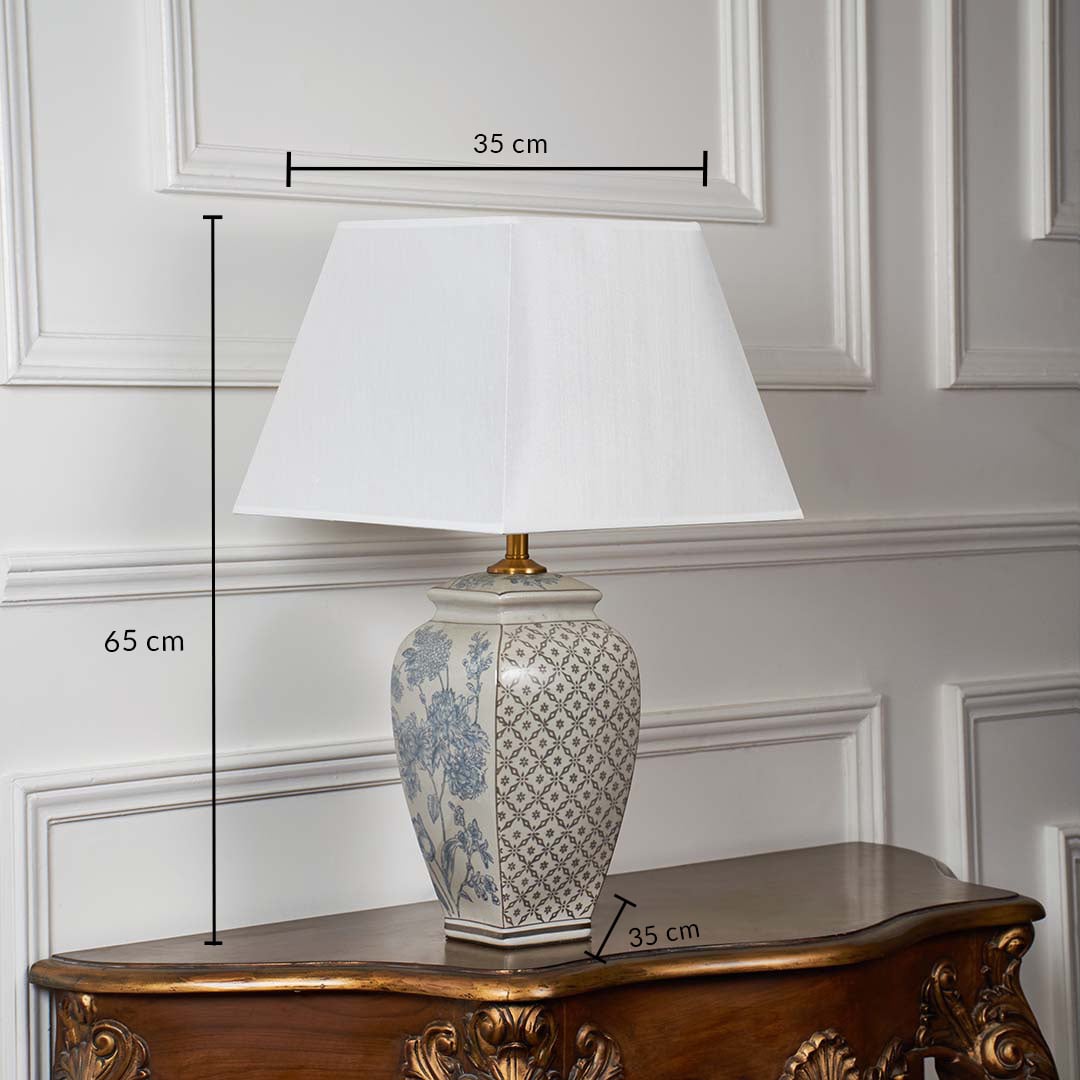 Ceramic table lamp with white shade displayed with measurements showing 65 cm height and 35 cm width on a white background.