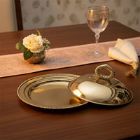Gold metal serving tray lifestyle image with glass dome cover for elegant luxury dining table decor.