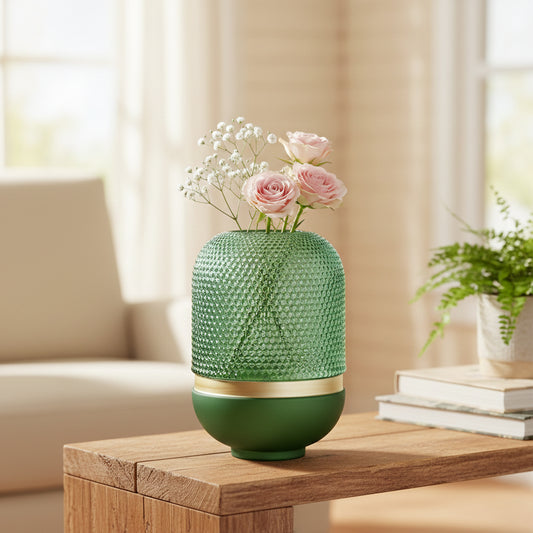 Green glass decorative vase styled with flowers on a table for elegant contemporary home decor and styling.