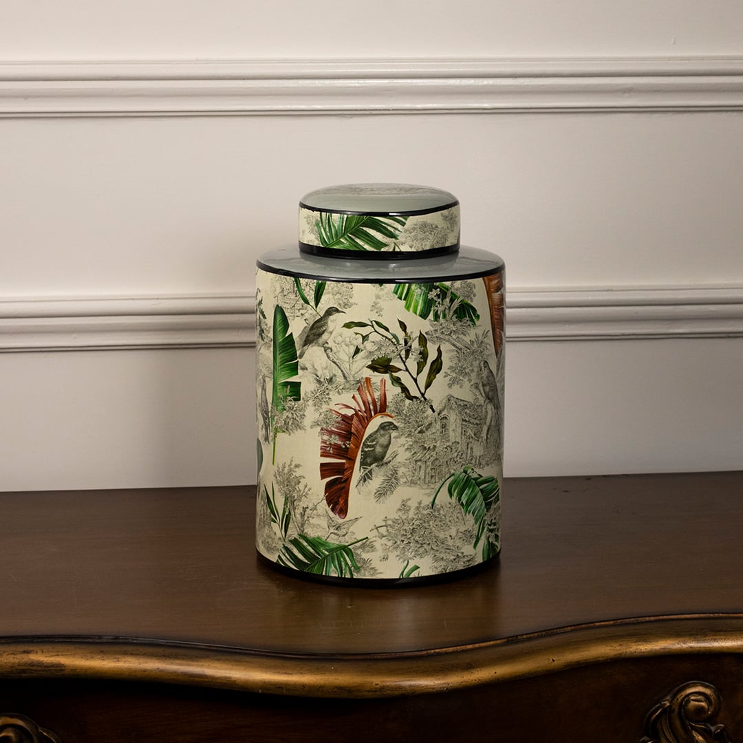 Tropical bird jar displayed on a white background showcasing detailed bird and leaf artwork.