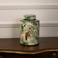 Tropical bird jar displayed on a white background showcasing detailed bird and leaf artwork.