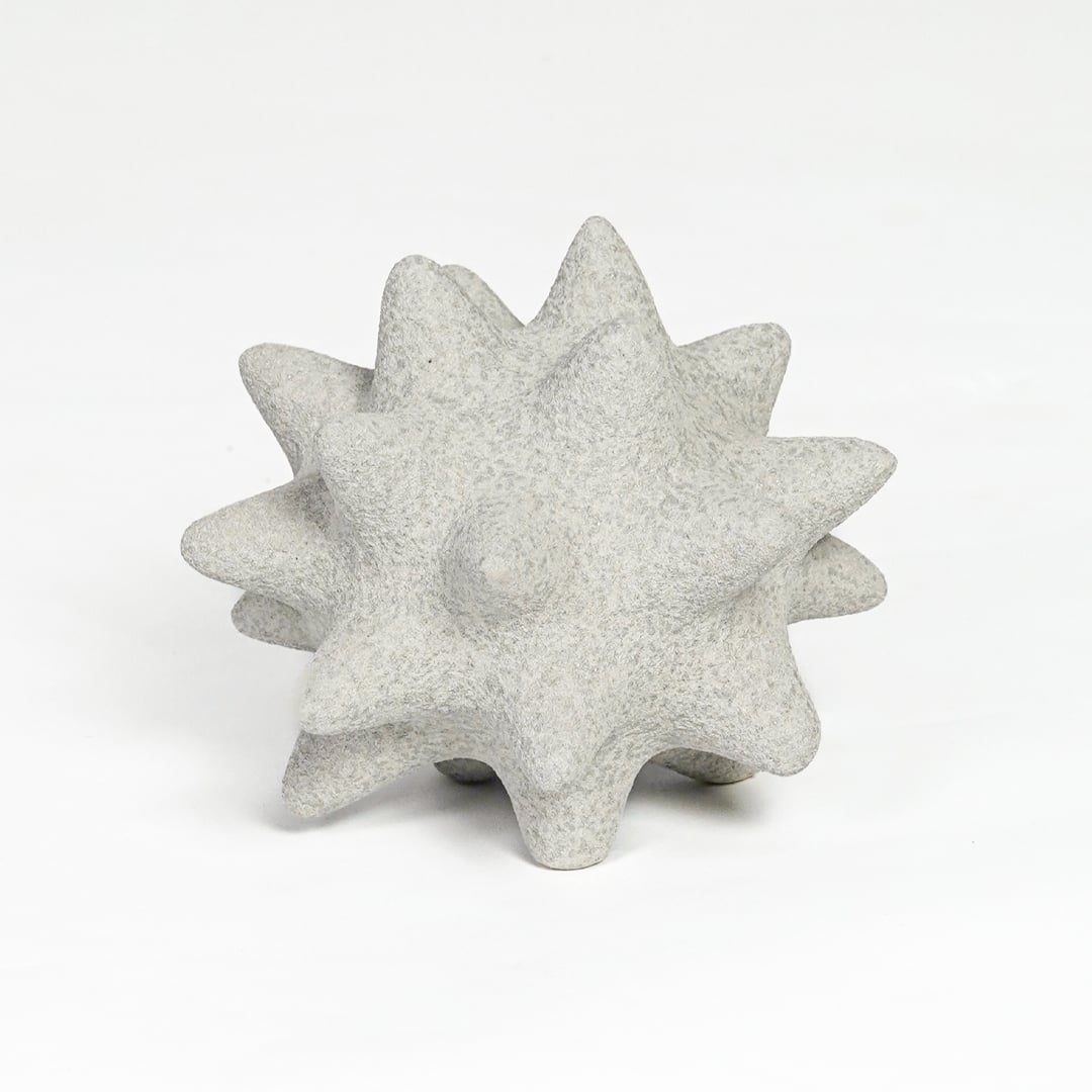 White ceramic star shaped decorative object with textured surface isolated on clean white background for tabletop decor display.