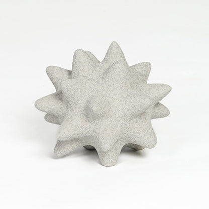 White ceramic star shaped decorative object with textured surface isolated on clean white background for tabletop decor display.