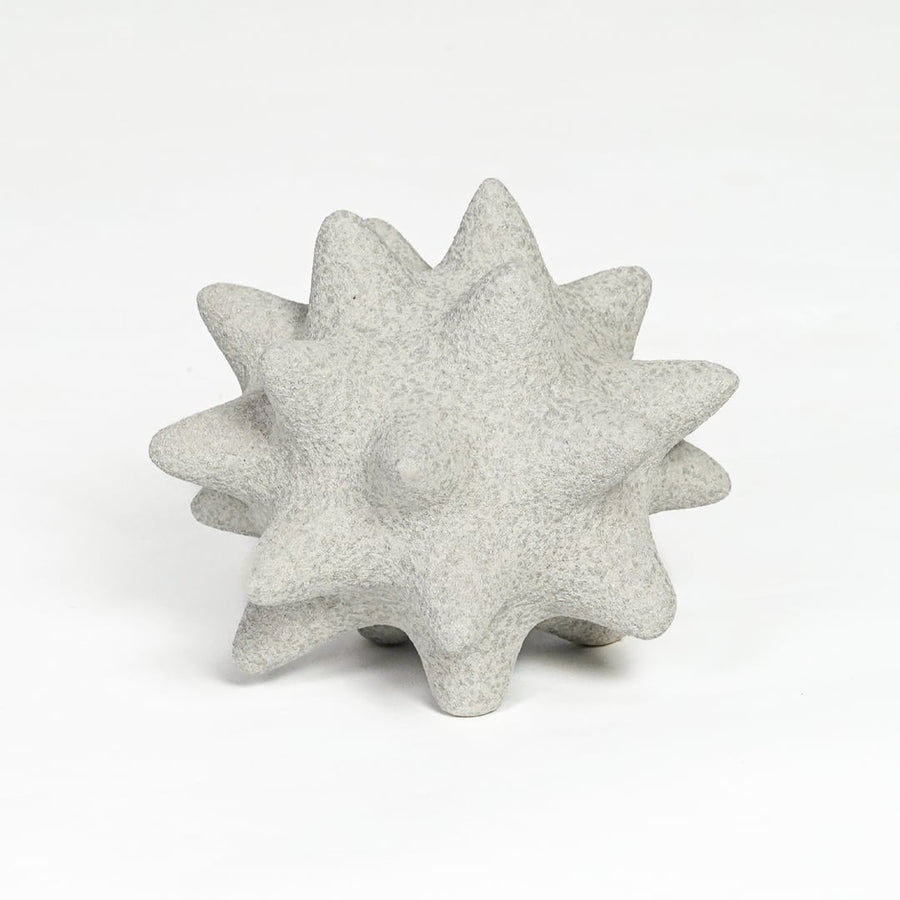 White ceramic star shaped decorative object with textured surface isolated on clean white background for tabletop decor display.