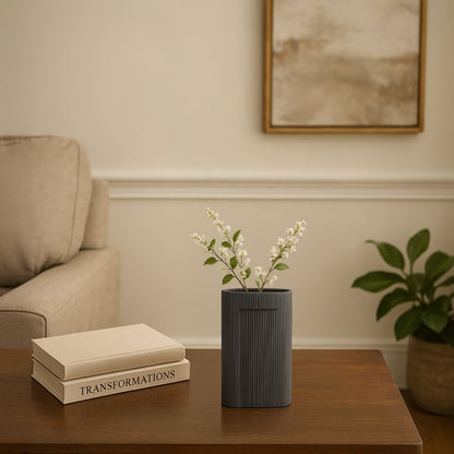 Dark grey textured ceramic vase with vertical ribbed pattern styled as modern table decor accent for contemporary living interiors.