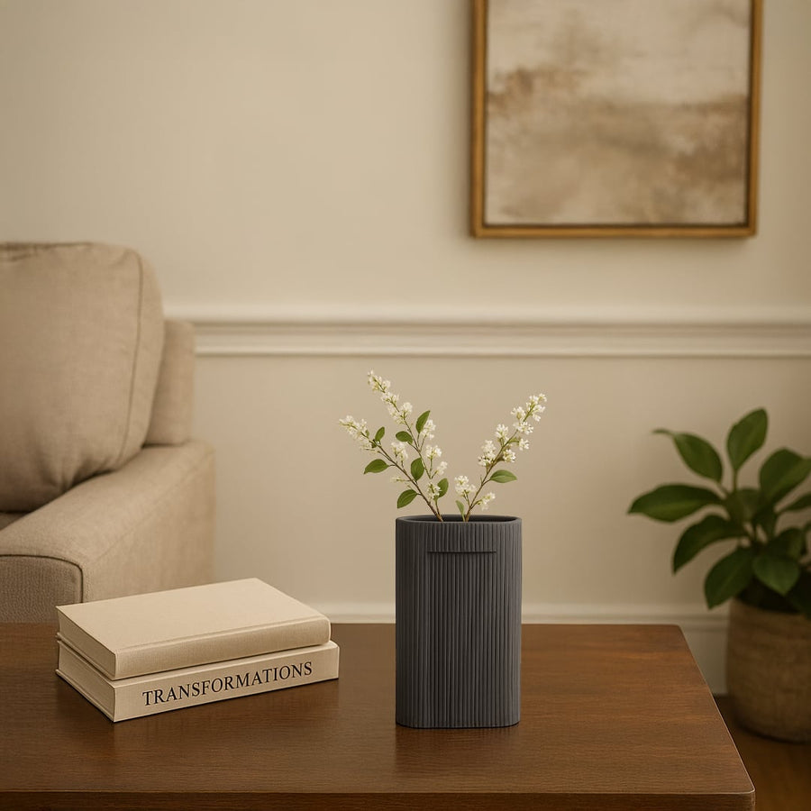 Dark grey textured ceramic vase with vertical ribbed pattern styled as modern table decor accent for contemporary living interiors.