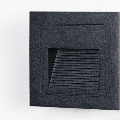 Closeup of black outdoor wall lantern showing geometric frame frosted glass panel and clean contemporary exterior design.