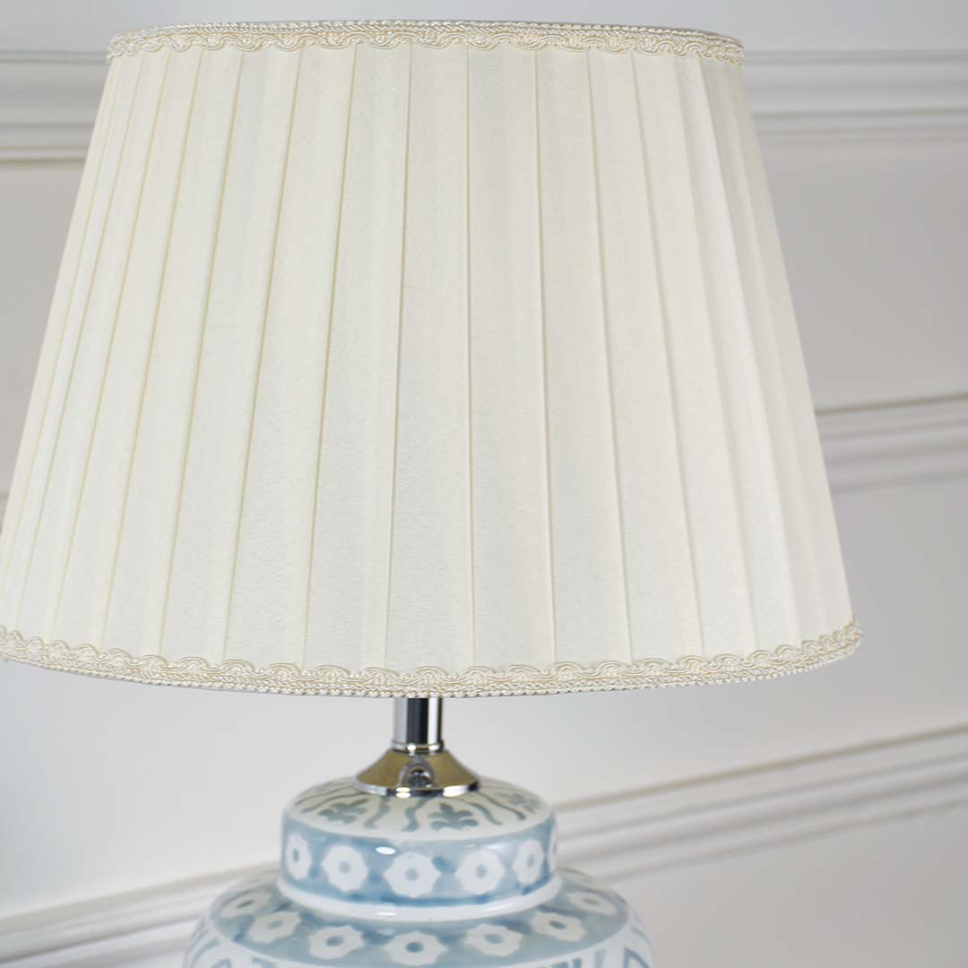 Pleated fabric lampshade showcasing fine craftsmanship and textured detailing for refined decorative table lighting.