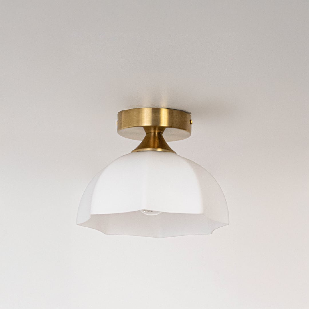 Modern white glass and gold metal ceiling light for stylish bedroom and premium interior decor styling spaces.