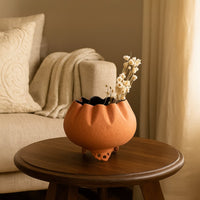 Terracotta metal scalloped bowl planter decor styled in a warm modern room adding an earthy elegant accent to living room tables.