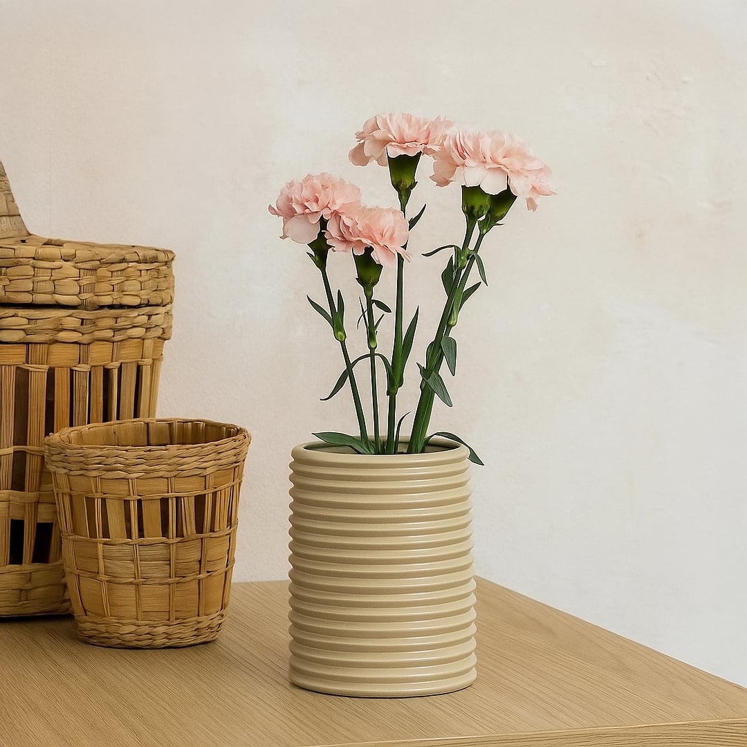Beige ribbed ceramic vase styled on tabletop adds modern elegance and minimal charm to living room or office decor.