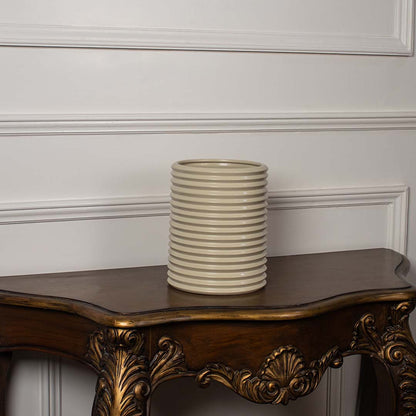 Beige ribbed ceramic vase with glossy texture shown on white background perfect for minimalist home decor styling.