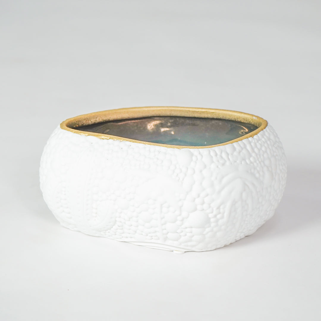 White textured ceramic bowl with gold rim for elegant dining table placement and modern decor styling centerpiece.