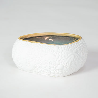 White textured ceramic bowl with gold rim for elegant dining table placement and modern decor styling centerpiece.