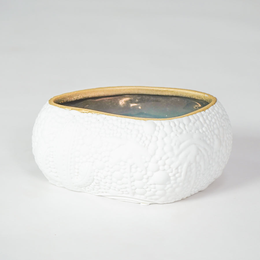 White textured ceramic bowl with gold rim for elegant dining table placement and modern decor styling centerpiece.