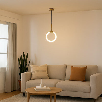 Modern gold pendant light glowing warmly above a cozy beige sofa in a minimalist living room interior decor.
