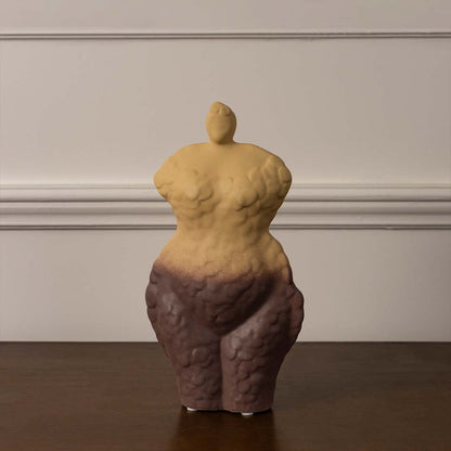 Modern ceramic torso sculpture vase with yellow and brown artistic gradient finish displayed on plain white background surface.