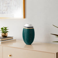 Teal ceramic decorative vase with gold detailing styled on a console table for elegant contemporary home decor.