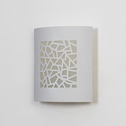 Minimal white ceramic wall light with geometric cutout front displayed off on clean white background.