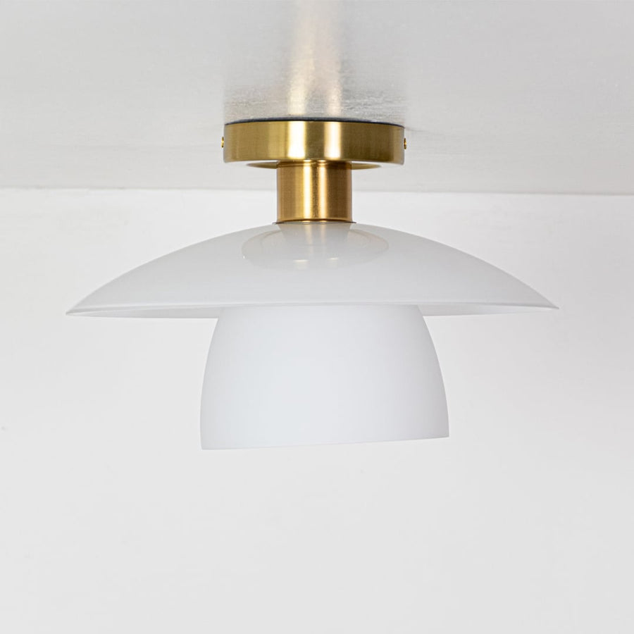 Gold metal ceiling light with smooth white glass shades displayed with lights off on a white background showing its clean contemporary shape.