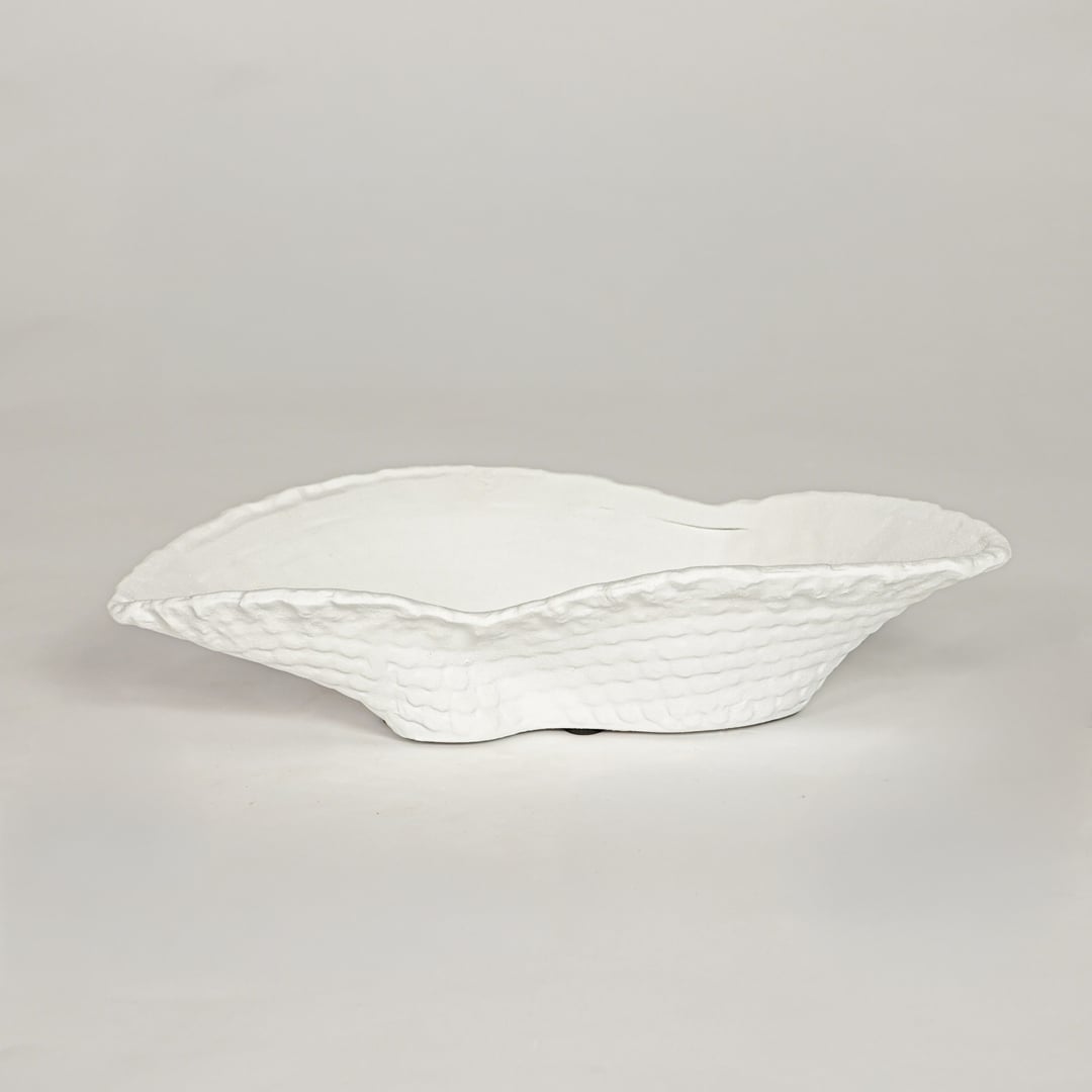 White ceramic decorative bowl with textured sculpted rim perfect for elegant dining table centerpiece and interior decor styling.
