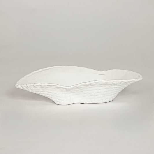 White ceramic decorative bowl with textured sculpted rim perfect for elegant dining table centerpiece and interior decor styling.