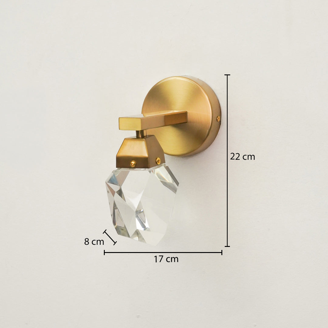 Gold wall-mounted sconce with a faceted clear crystal shade, shown with dimension annotations indicating 22 cm height, 17 cm width, and 8 cm shade depth on a plain light background.