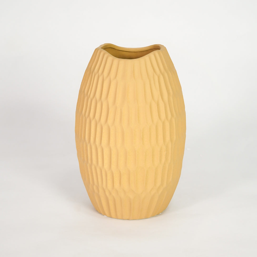 Yellow ribbed ceramic vase for elegant shelf placement and modern living room decor styling accent piece.