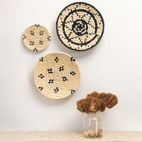 Set of natural woven decorative wall baskets with artistic patterns for elegant wall styling and bohemian home decor.