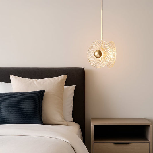Elegant crystal and gold pendant ceiling light glowing beside modern bed with neutral decor and wooden nightstand