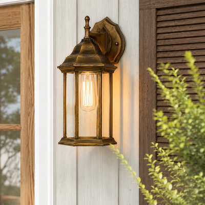 Antique brass metal hexagonal glass wall sconce lantern on white vertical siding next to wooden shutter for home porch.