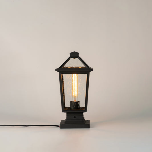 Black outdoor gate light with ribbed glass panels for stylish modern exterior decor use.