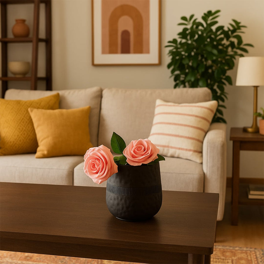 Small black textured pot with matte finish styled in a warm modern home setting adding bold minimal decor to tables and shelves.