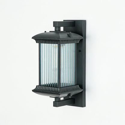 Minimal black outdoor wall light with vertical ribbed glass shade on neutral wall background ideal for garden or patio lighting.