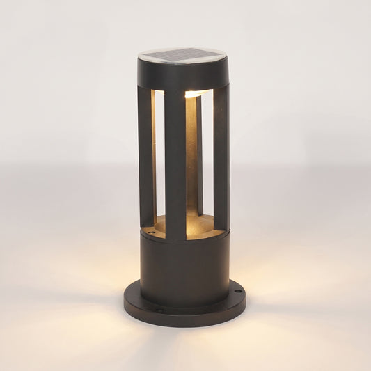 A modern outdoor bollard light with a matte black finish, featuring a solar panel on top and warm white LED lighting inside a cylindrical frame, set against a clean white background.