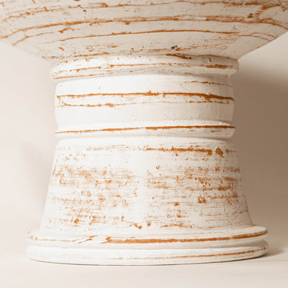 Close-up view of pedestal bowl showing its detailed grooved lines ear handles and artisanal craftsmanship.