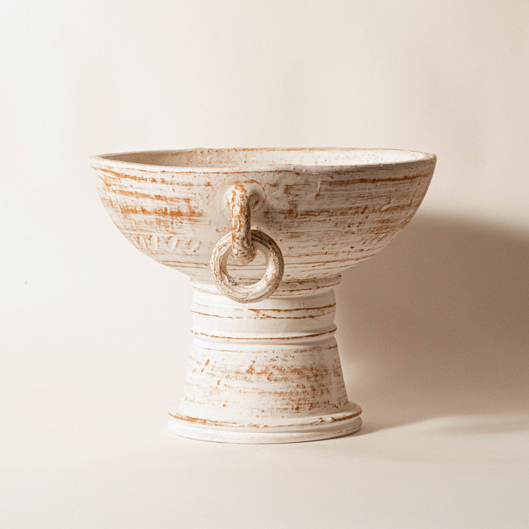 Decorative ceramic bowl in beige finish with sculpted handle detail for table decor or centerpiece styling modern home placement white background.