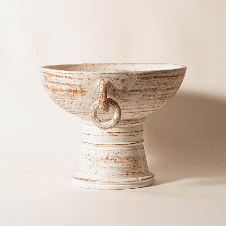 Decorative ceramic bowl in beige finish with sculpted handle detail for table decor or centerpiece styling modern home placement white background.