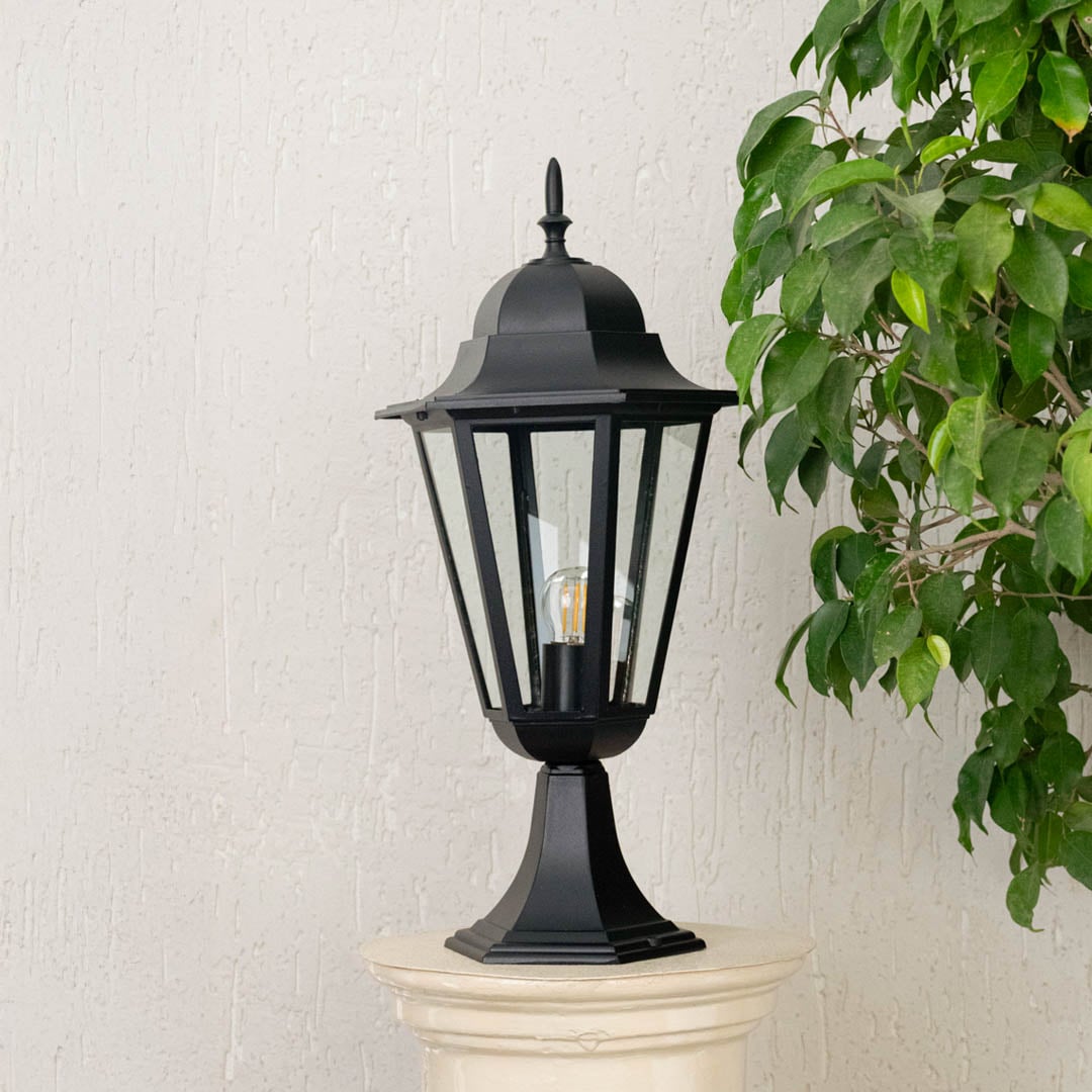 Classic black pillar lamp placed on stone pillar with light off enhancing outdoor entrance and elegant home garden ambiance.