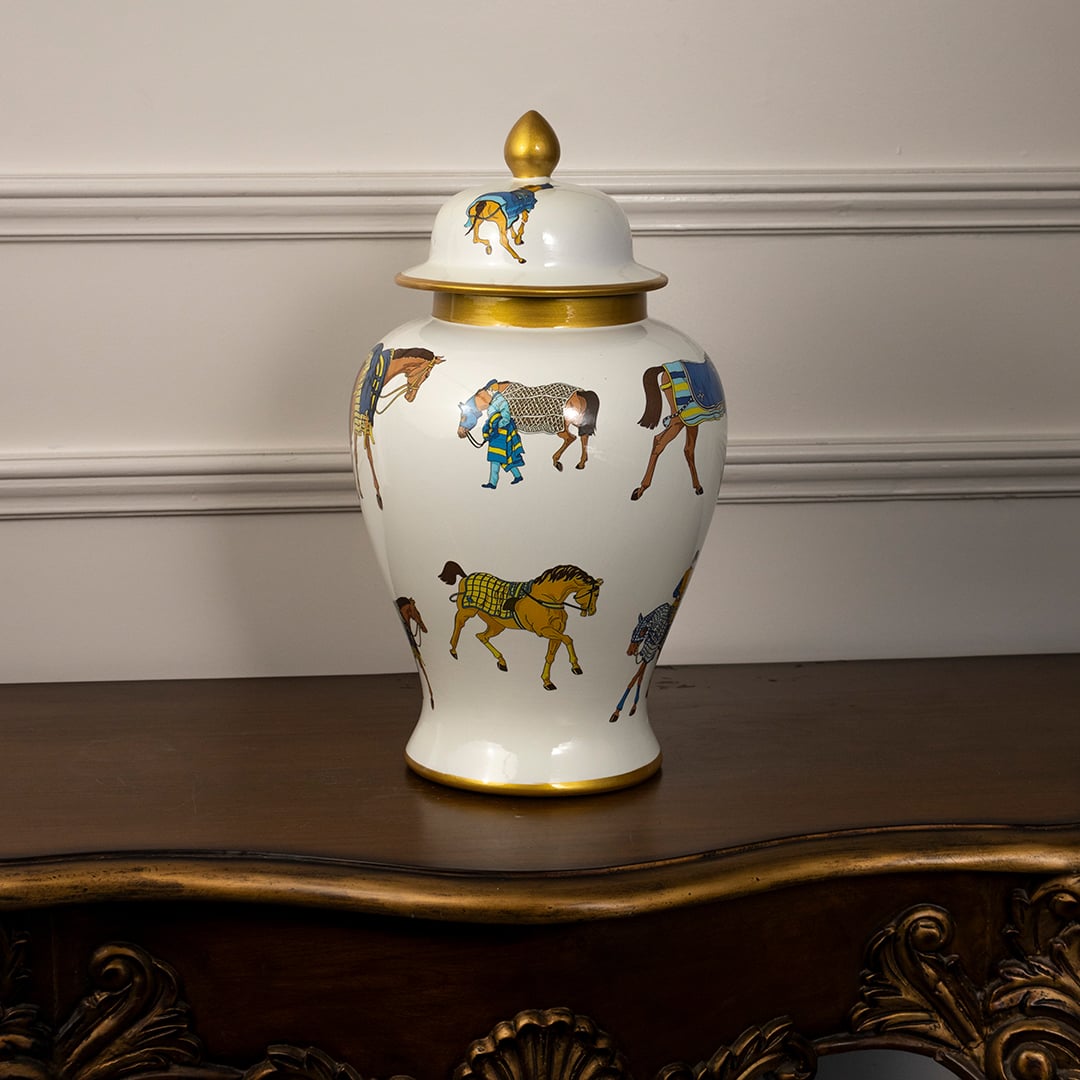 Elegant white ceramic jar with golden lid and multicolor horse print perfect for luxury home or tabletop decoration.