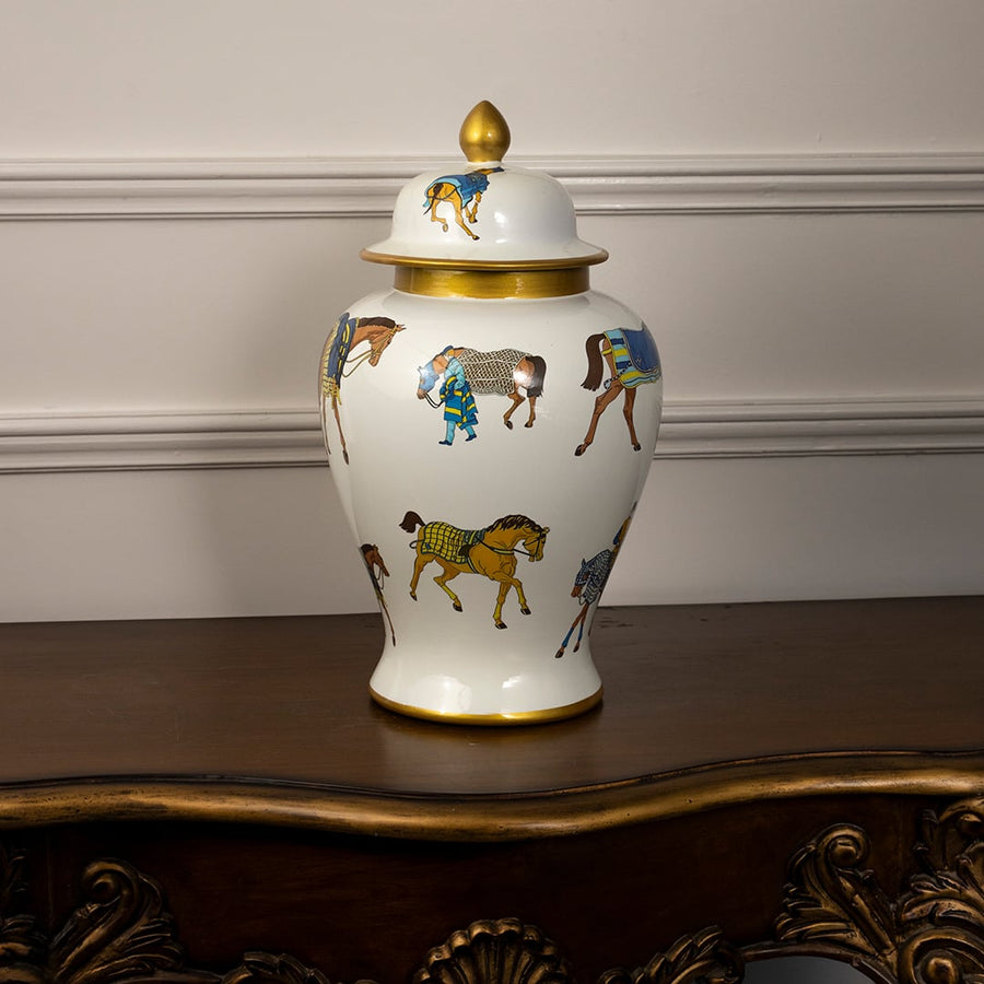 Elegant white ceramic jar with golden lid and multicolor horse print perfect for luxury home or tabletop decoration.