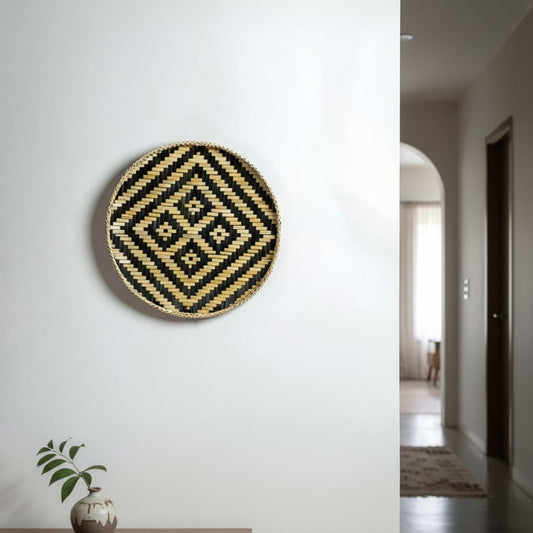 Geometric round wall decor in black and gold finish mounted on white wall enhancing modern hallway styling with bold visual appeal.
